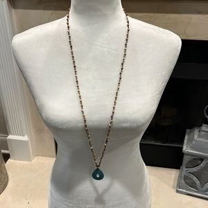 Brown beaded necklace with turquoise colored pendant. Listing# 454